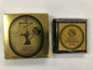 Packaging of Bukhoor Dirham Gold with branding and product name visible, predominantly gold colored from Malik Foodstore